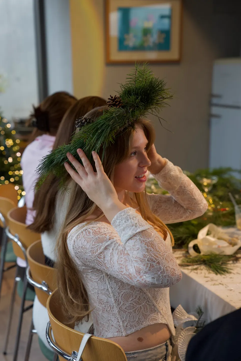A participant wearing her handmade Christmas wreath