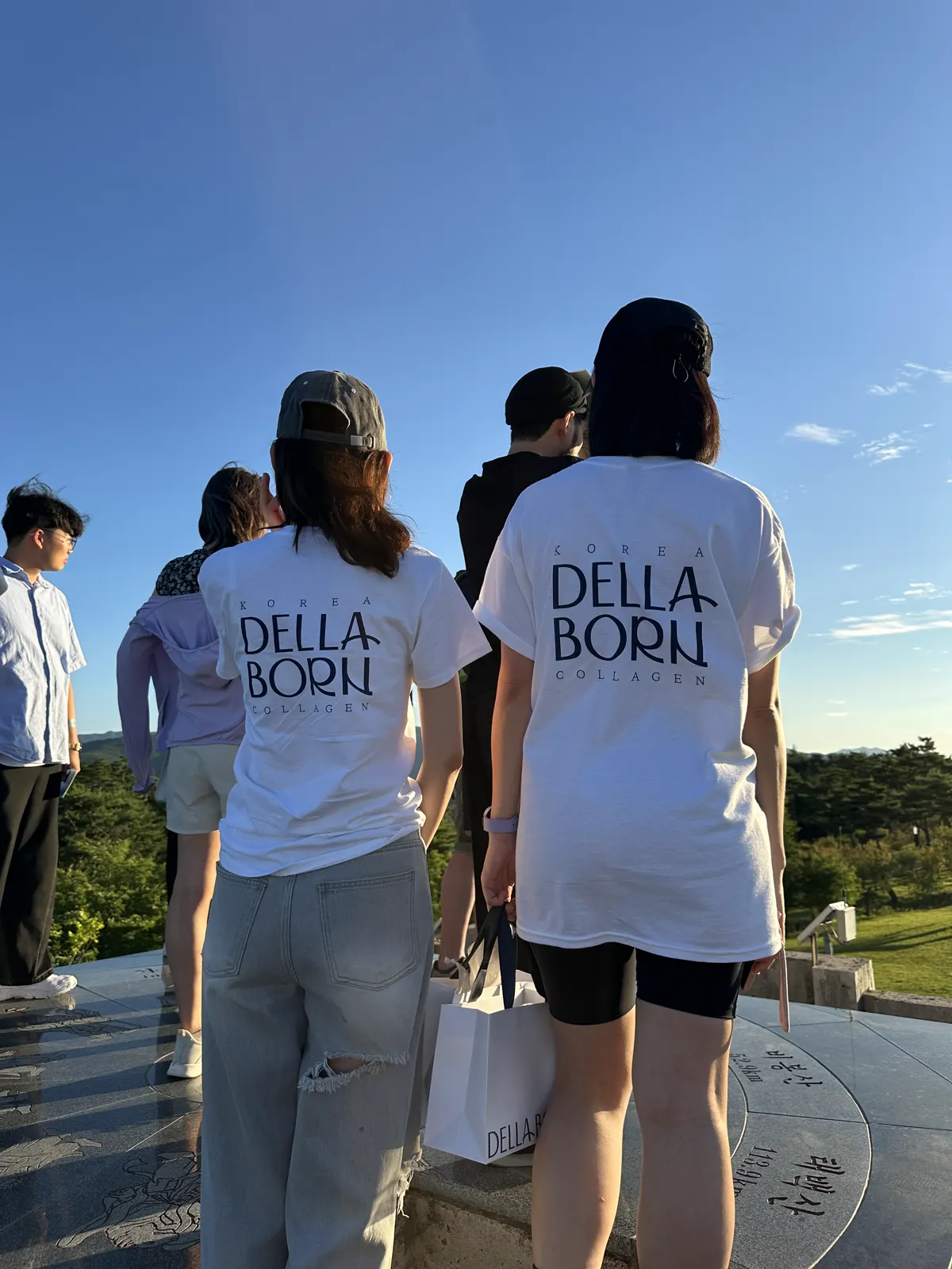 Members wearing DELLA BORN shirts at the event
